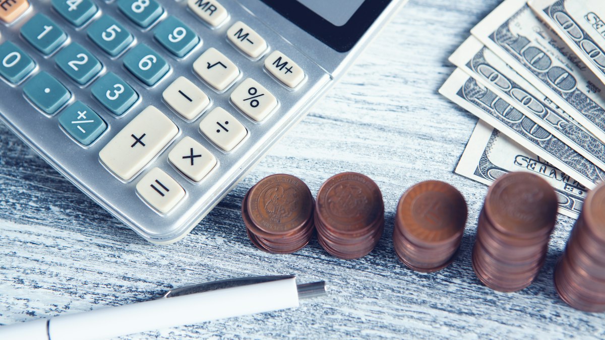 Calculator, pen and money for planning salary expectations in Australia